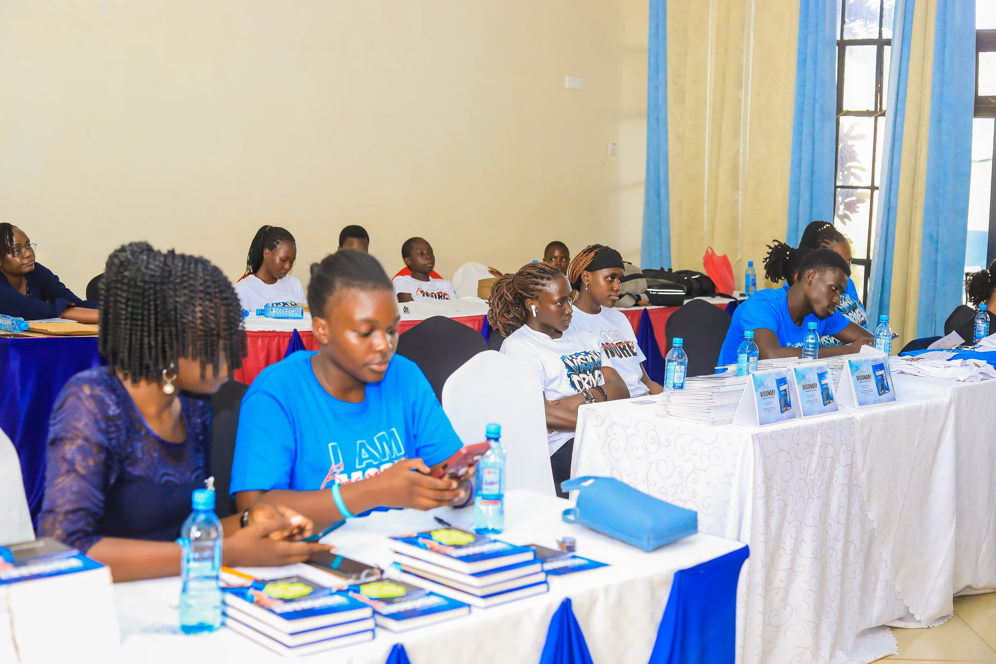 The book and merchandise display desks with support team during the official launch event held in Kisumu City venue
