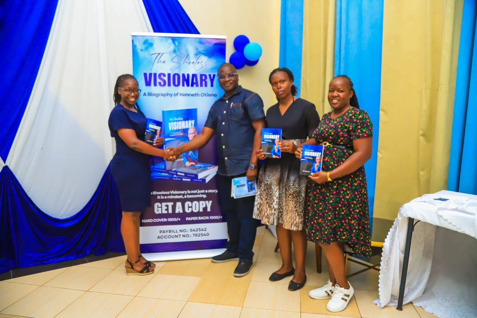 Everline Owino Isabel Naibei and Doreen Nafula receive their book copies during the launch event held in Kisumu City